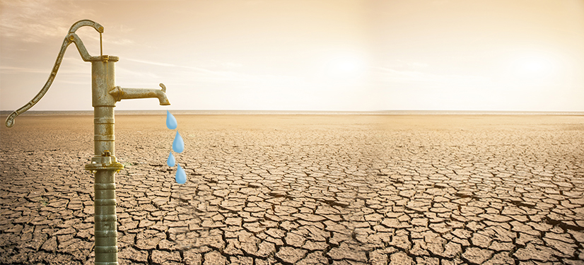 Image of dry, arid land with a tap of water dripping water